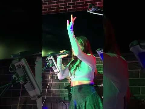 Yowzza’s performance clip thumbnail, showing a vocalist on stage.